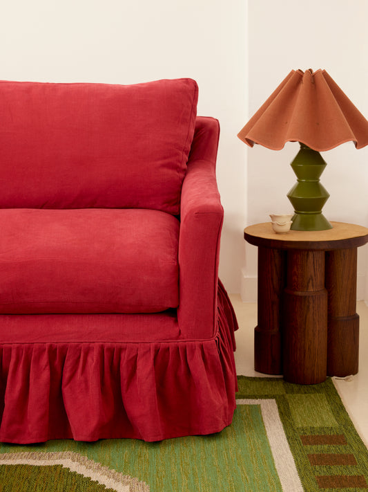 Red frill slipcover Sonder sofa with Ziggy green lamp and terracotta wavy shade