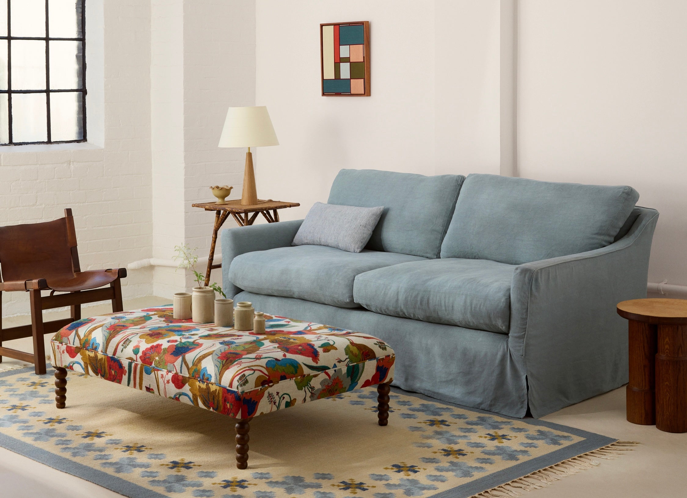 Blue linen Sonder sofa with Wish ottoman in California print 