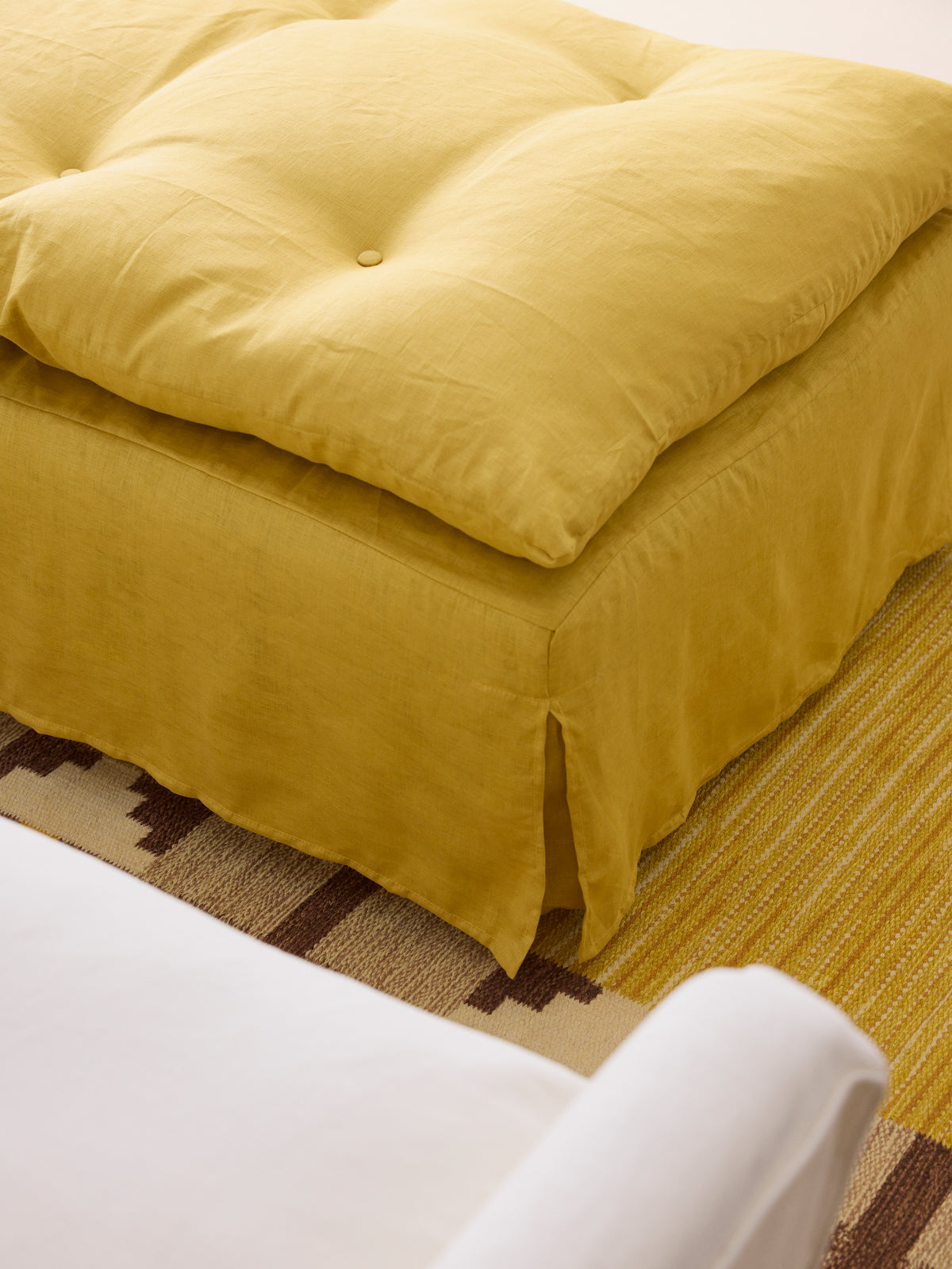 Maro Home Stowe ottoman with tailored linen cover and feather cushion topper